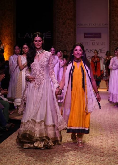 Ritu Kumar as seen in a picture walking the ramp alongside actress and model Nargis Fakhri at the Lakme Fashion Week at Grand Hyatt Mumbai on August 26, 2013