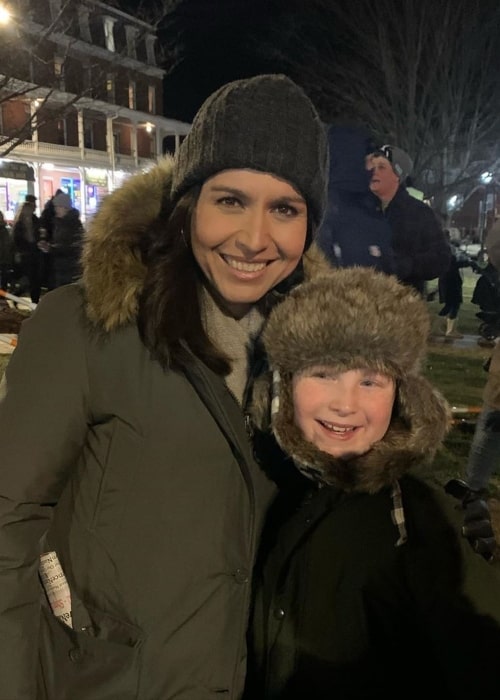 Tulsi Gabbard as seen in a picture taken while she poses in a picture with a child at the Nashua's Winter Holiday Stroll in Southern New Hampshire in December 2019