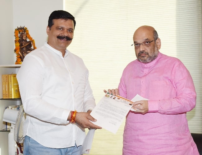 Amit Shah (Right) as seen while posing for the camera along with politician Kunwar Pranav Singh in September 2017