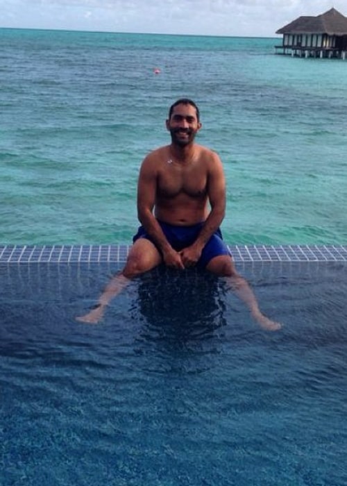 Dinesh Karthik as seen in a picture while he soaks his feet in a pool of water in June 2014
