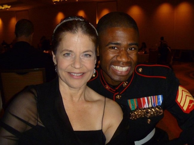 Linda Hamilton smiling in a picture alongside Marine Sgt. Raymond Lewis at the Marine Corps Birthday Ball on October 29, 2011, in Westlake, Texas, United States