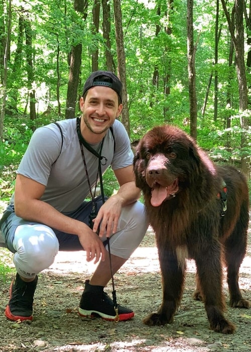 Mikhail Varshavski as seen while smiling in a picture taken while enjoying a hike with his pet, Bear Varshavski, at Ramapo Valley County Reservation in Mahwah, New Jersey, United States in August 2019