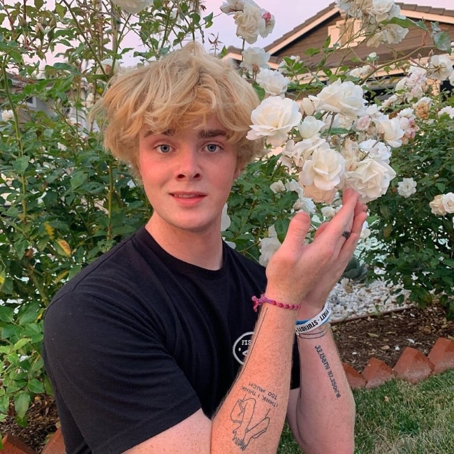 Alex Warren as seen while posing for a picture with the flowers in July 2019