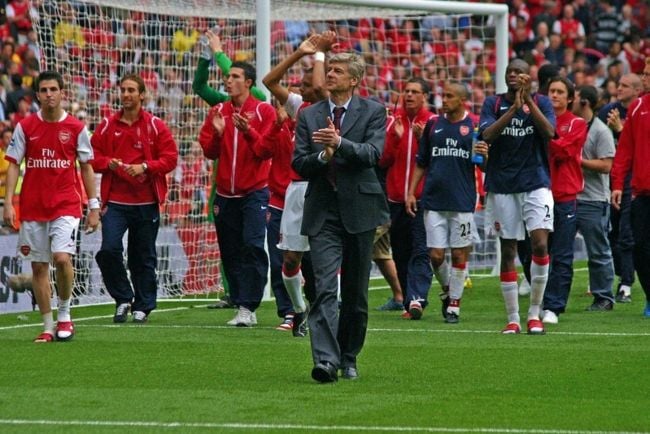 Arsène Wenger seen with Arsenal players in the background after a match in 2007