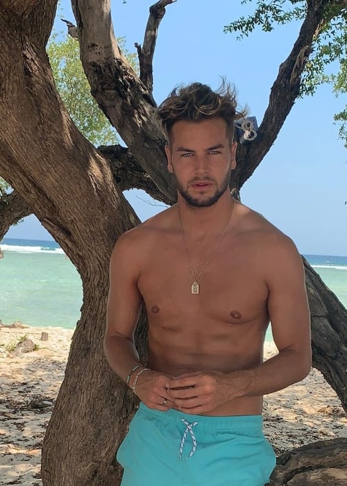 Chris Hughes as seen while posing shirtless for the camera in October 2019
