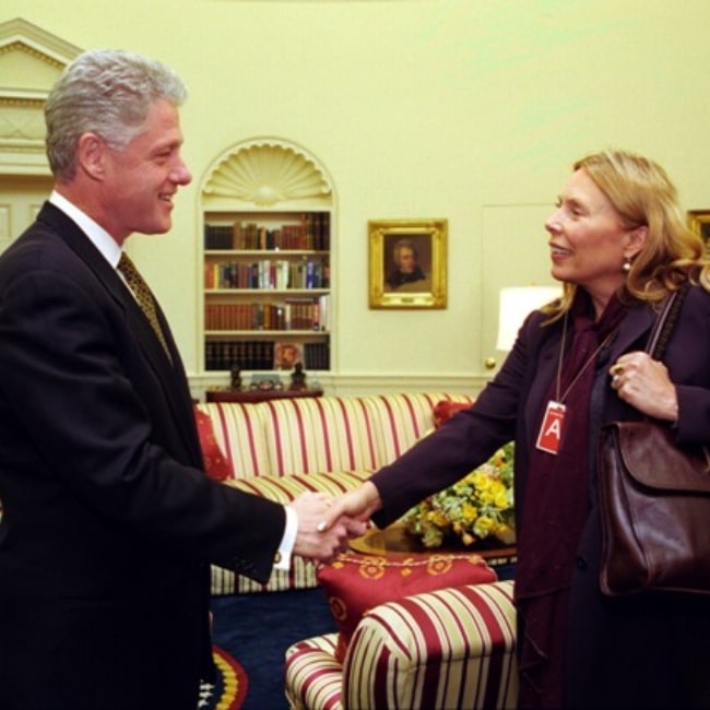 Joni Mitchell as seen in a picture taken while shaking the hand of the 42nd President of the United States Bil Clinton in the Oval Office on May 11, 1998