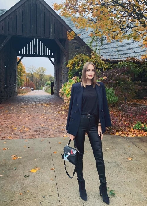 Jules Mordovets posing for a picture with a serene backdrop at Blue Hill At Stone Barns in Tarrytown, New York in October 2019