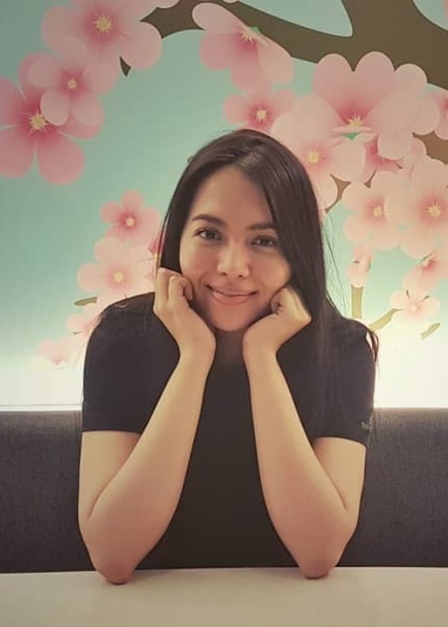 Julia Montes as seen while posing for a picture with cherry blossoms painted on the wall behind her in May 2018