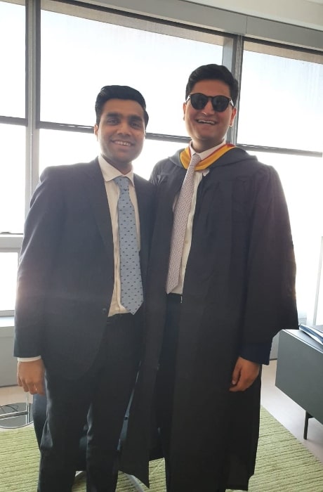 Karan Adani (Left) smiling in a picture alongside his brother, Jeet Adani, in May 2019