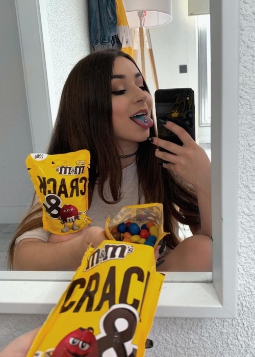 Monica Moran as seen in a selfie taken while holding a bag of M&M's in May 2019 in Community of Madrid, Spain