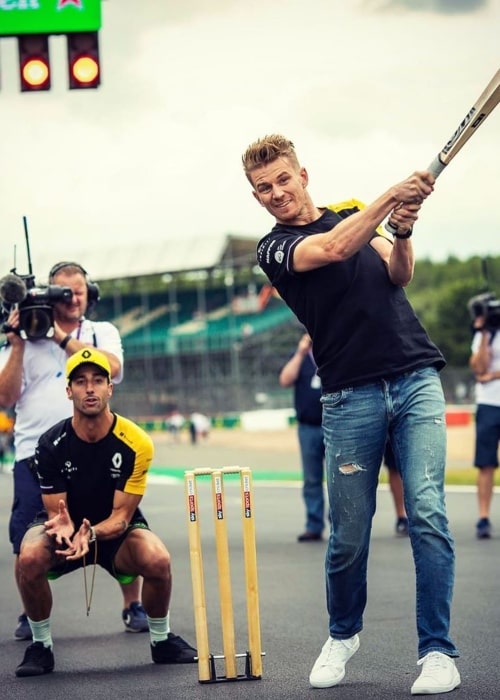 Nico Hülkenberg and Daniel Ricciardo playing Cricket on the sidelines of the 2019 British Grand Prix at the Silverstone Circuit