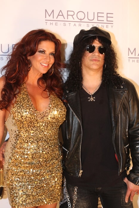 Slash posing for the camera alongside Perla Hudson at the Marquee The Star, Sydney opening in March 2012