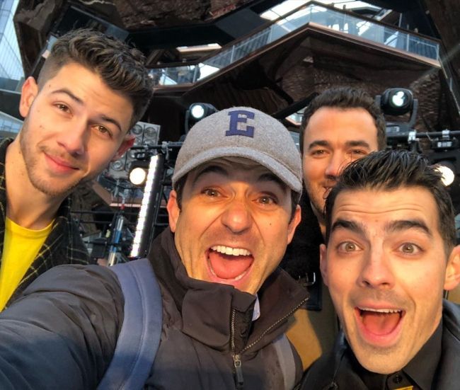 Fred taking a selfie with the Jonas Brothers (Nick Jonas, Kevin Jonas, and Joe Jonas) in 2019