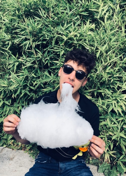 Iván Cobos as seen in a picture taken while he relishes cotton candy at the Parque de Atracciones in July 2018