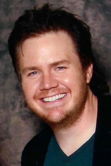 Josh McDermitt as seen while smiling in a picture at Walker Stalker Convention 2014