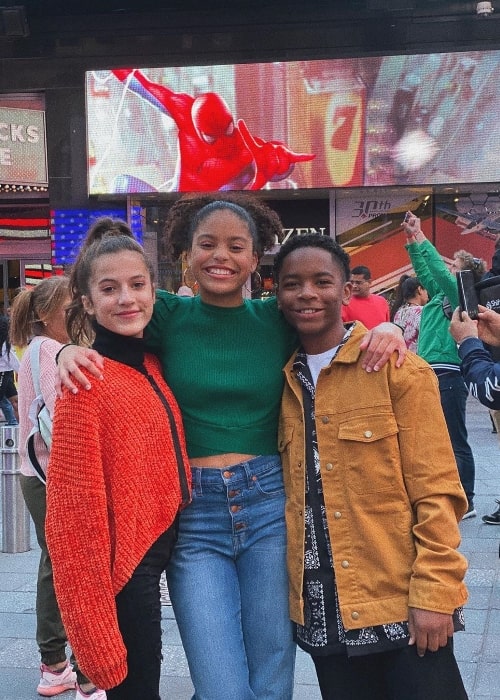 Kai Calhoun as seen while smiling in a picture along with Symera Jackson (Center) and Eliza Pryor at Times Square, New York City, New York in October 2019