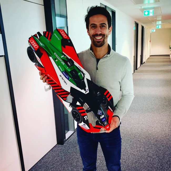 Lucas di Grassi with a miniature 3D-printed Formula E racecar, as seen in November 2019