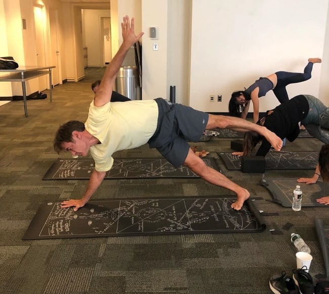 Mehmet Oz participating in team yoga in August 2019