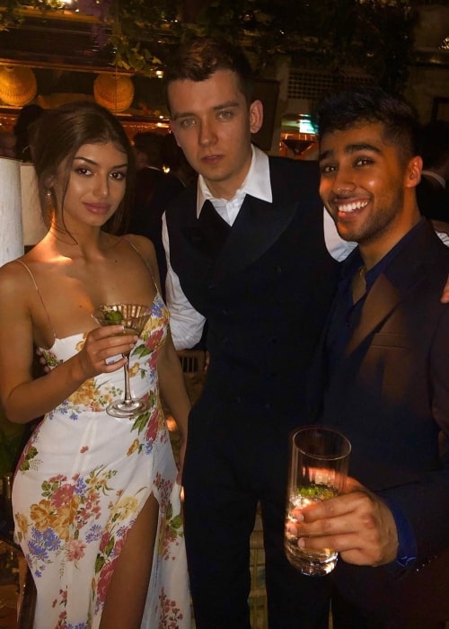 Mimi Keene as seen while posing for a picture alongside Asa Butterfield (Center) and Chaneil Kular at the Chiltern Firehouse in London, England in February 2020