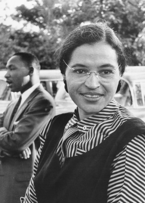 Rosa Parks as seen while smiling in a picture with Dr. Martin Luther King Jr. in the background in 1955