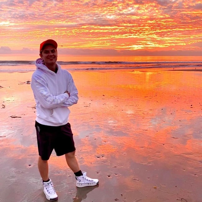 Carter Sharer as seen while posing for a picture by the beach enjoying the sunset in Malibu, California in December 2019