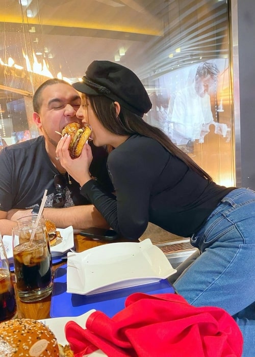 Marialejandra Marrero as seen in a picture taken with her husband Luis Valentino while relishing a burger together in March 2020