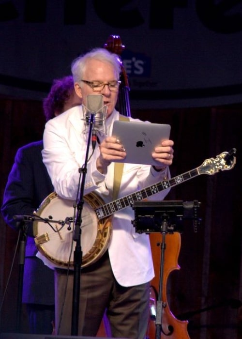 Steve Martin pictured while reading his 'thousand-dollar set list' at MerleFest in 2010