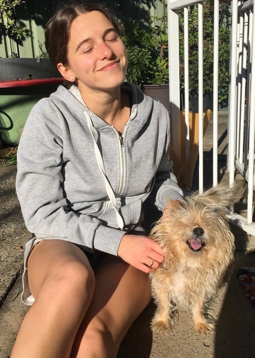 Tess Begg smiling in a picture alongside her late dog Mickey