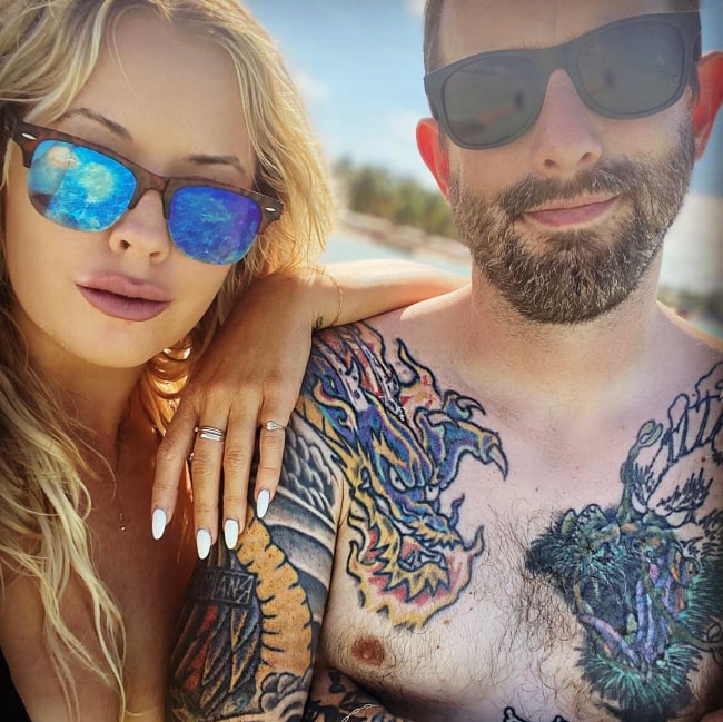 Geoff Ramsey posing shirtless alongside Emily Hatfield in December 2019