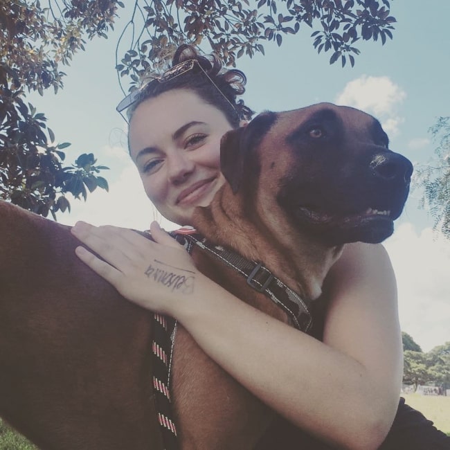 Ivy Latimer as seen while smiling in a picture with a dog in February 2019