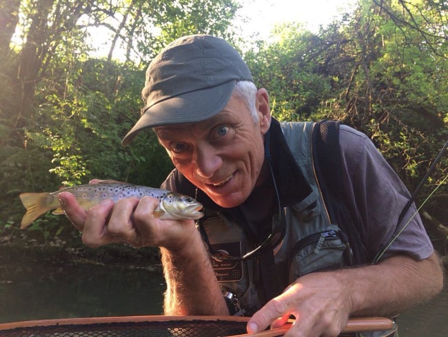 Jeremy Wade holding a brown trout, as seen in May 2018