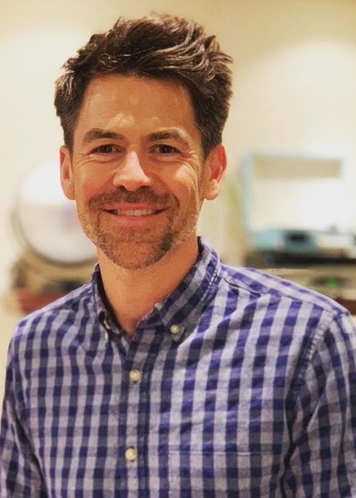 Kyle Howard smiling for a picture wearing his favorite blue shirt while observing the Colon Cancer Awareness Month in March 2019