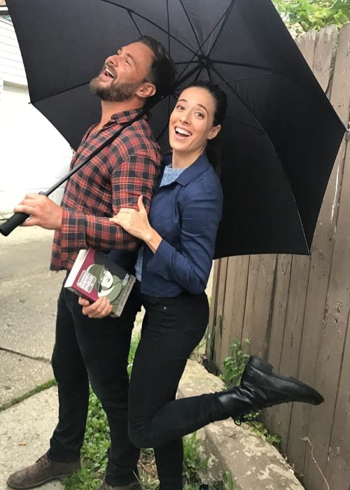 Marina Squerciati having fun with her co star Patrick Flueger under an umbrella in August 2019