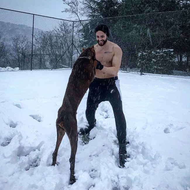Ekin Mert Daymaz having fun with his pet dog in February 2019