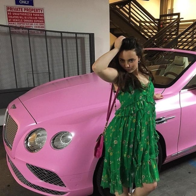 Freya Tingley as seen in a picture while posing front of a pink Bentley in April 2019
