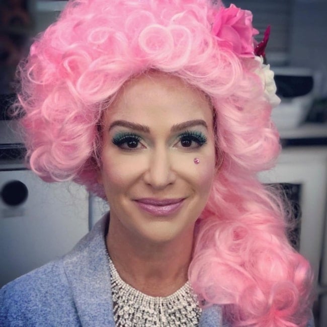 Rebecca Creskoff as seen in a closeup picture while sporting a pink wig in July 2019