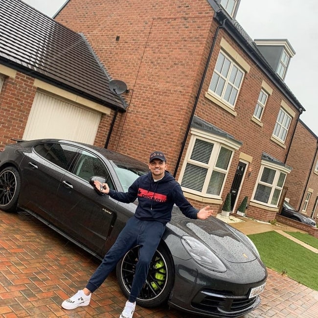Sam Gowland posing with his new car in June 2020