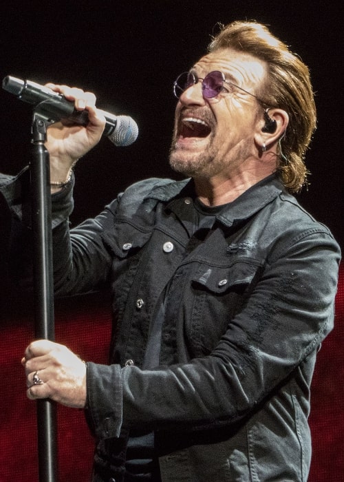 Bono pictured while singing during U2's performance at Lucas Oil Stadium in Indianapolis, Indiana on September 10, 2017