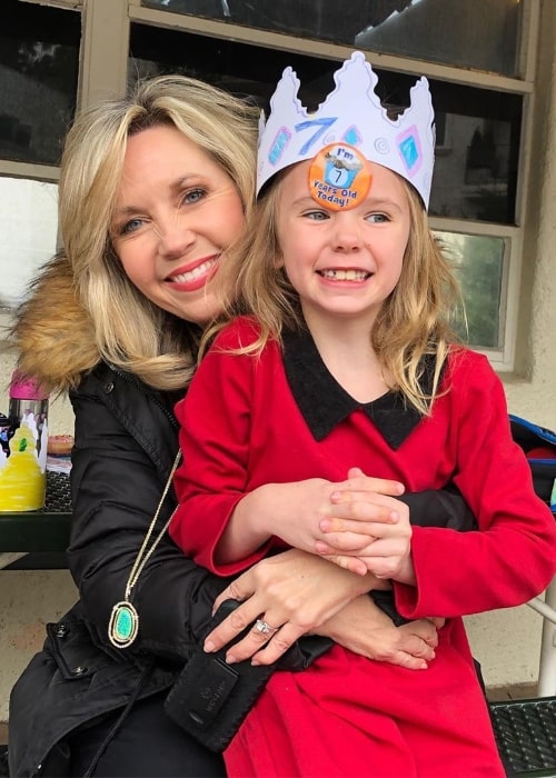 Deb Carson smiling in a picture alongside her daughter celebrating her 7th birthday in December 2019