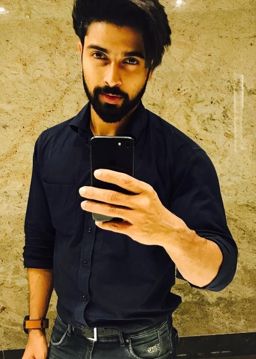 Dev Mohan as seen while taking a mirror selfie in February 2018