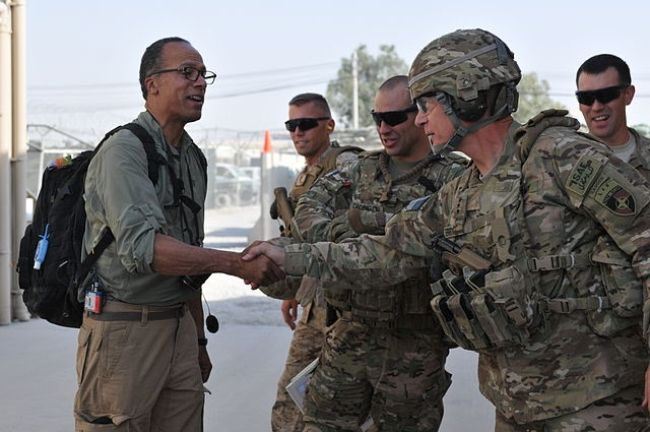 Lester Holt shaking hands with ISAF Joint Command Commander Lt. Gen. James Terry in 2012