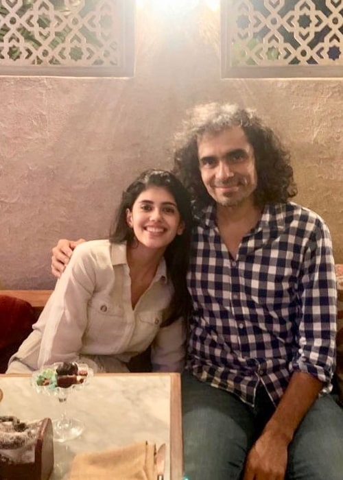 Sanjana Sanghi smiling for a picture alongside Imtiaz Ali in November 2019