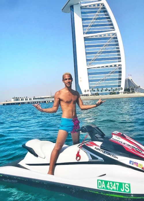 Simon Desue as seen while standing shirtless on a jet ski in front of the Burj Al Arab in Dubai in May 2020