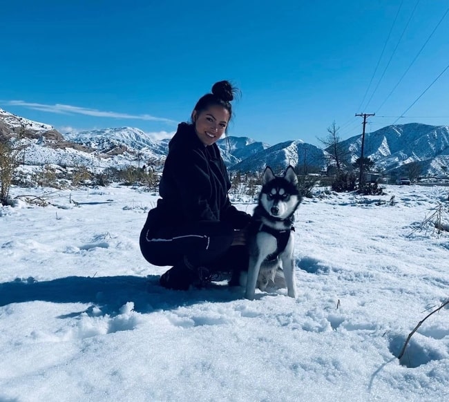 Constance Nunes posing for a picture along with her husky Buff in Wrightwood, California in December 2019