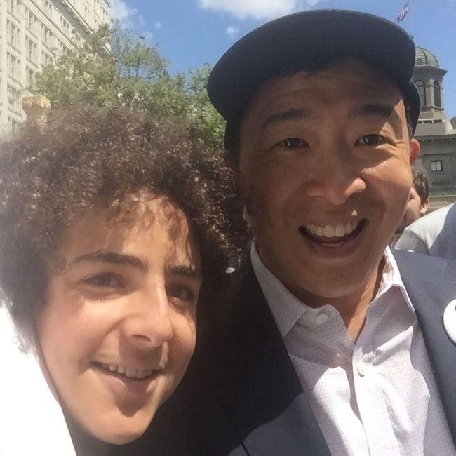 Elisha Henig (Left) as seen while smiling in a picture alongside Andrew Yang in Portland, Oregon in July 2019