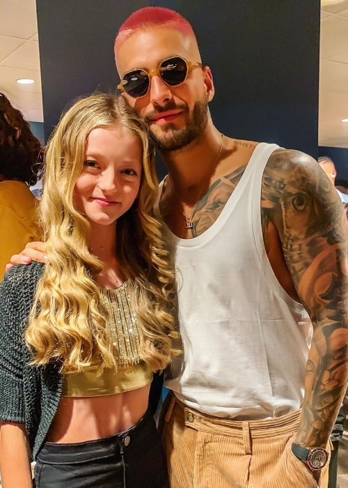 Emily Dobson smiling in a picture alongside Maluma at The Forum in Inglewood, California in September 2019