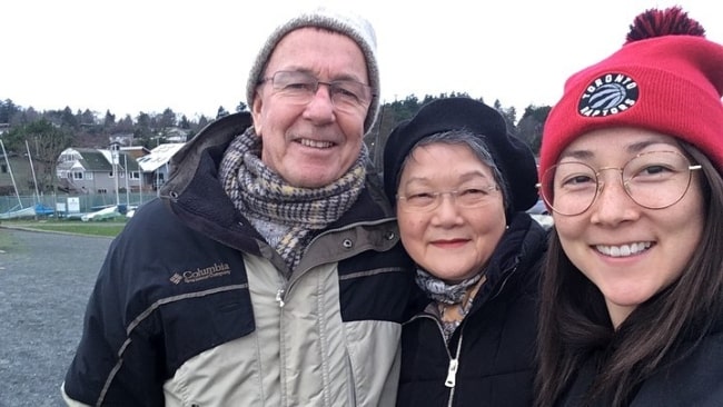 Emily Piggford smiling in a selfie along with her parents in December 2019