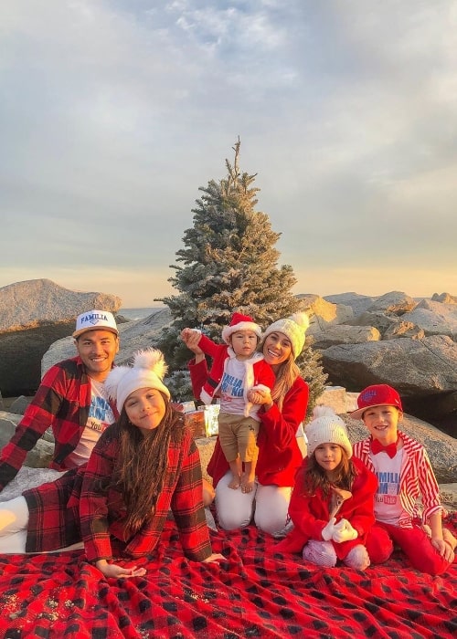 Esthalla smiling in a Christmas picture with her family in December 2019