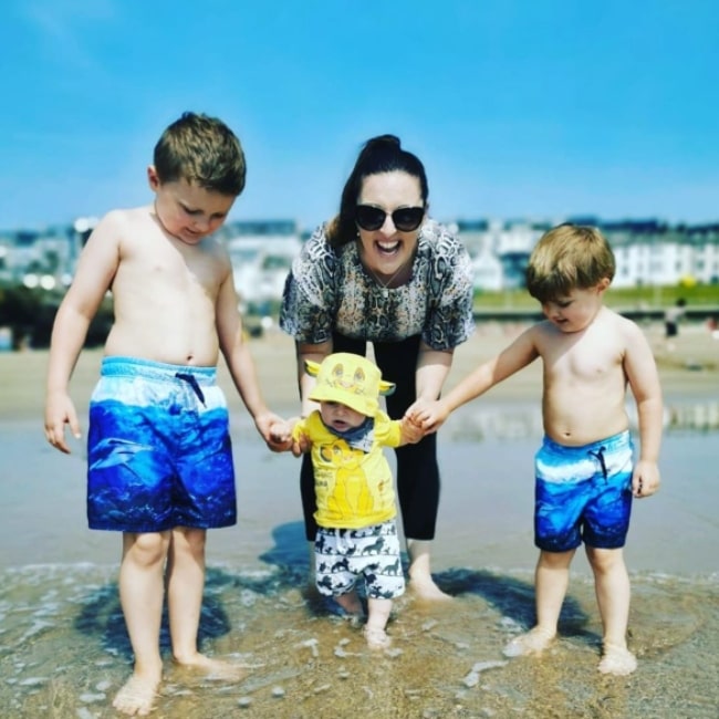 Jenna McCorkell by the sea with her son Ben and his cousins Jake and Max in July 2020