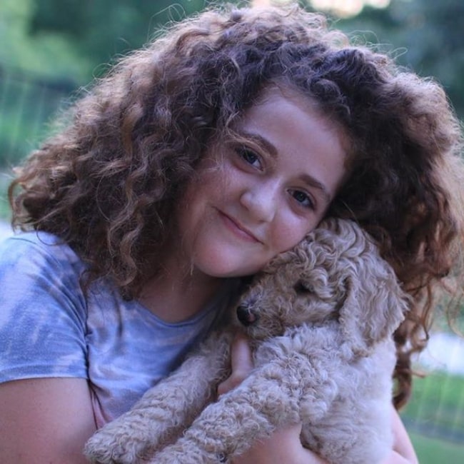 Julia CraftyGirls as seen in a picture with her Poodle named Lily in July 2019